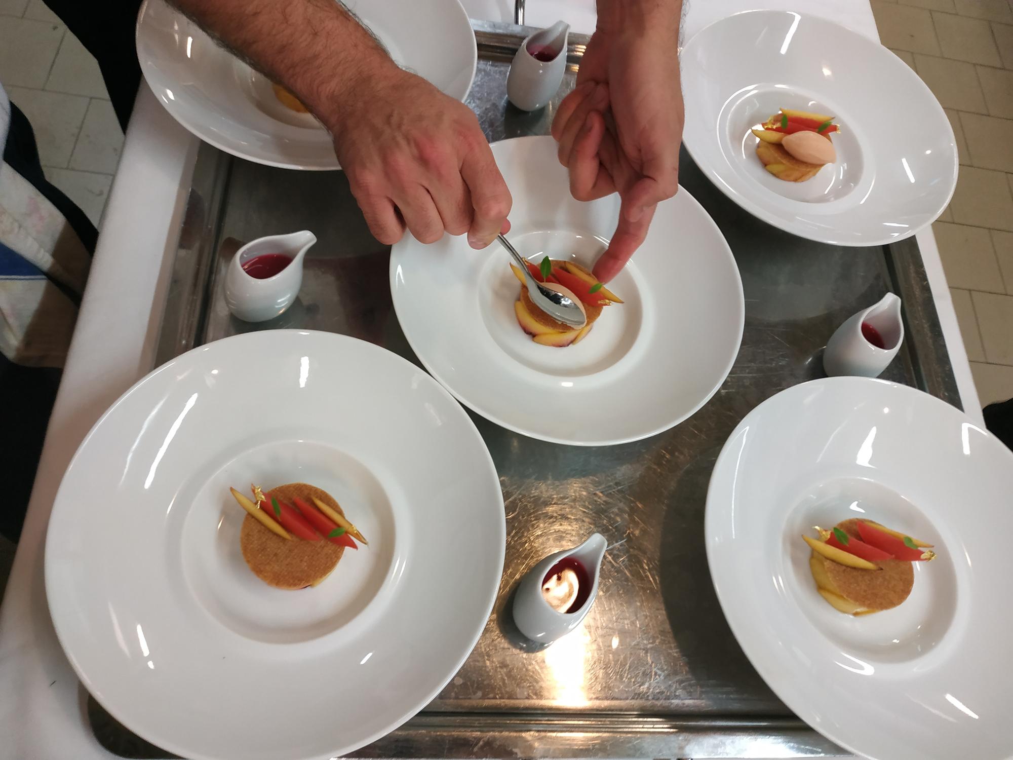 Chef demonstrating plating technique in workshop